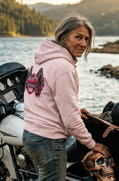 Back of the pink Angel Skull premium hoodie on a rider beside her motorcycle