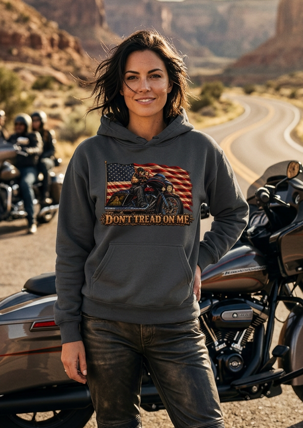 Woman leaning against a motorcycle wearing the charcoal gray HawgDogs Don't Tread Doggo Ultimate Fleece-147 Hoodie showing the front graphic