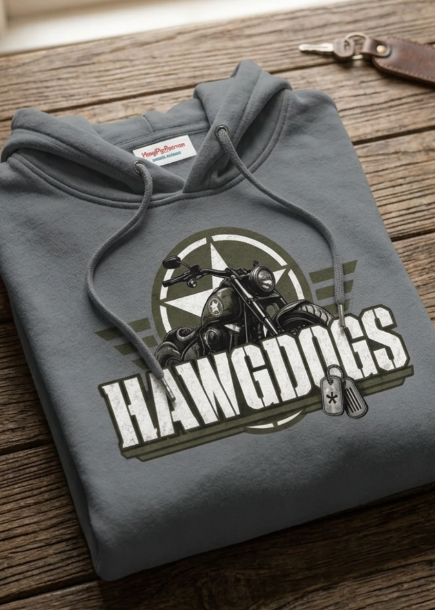 Front of the gray Might of The Republic premium hoodie with the small HawgDogs chest logo, laid flat on a wooden table