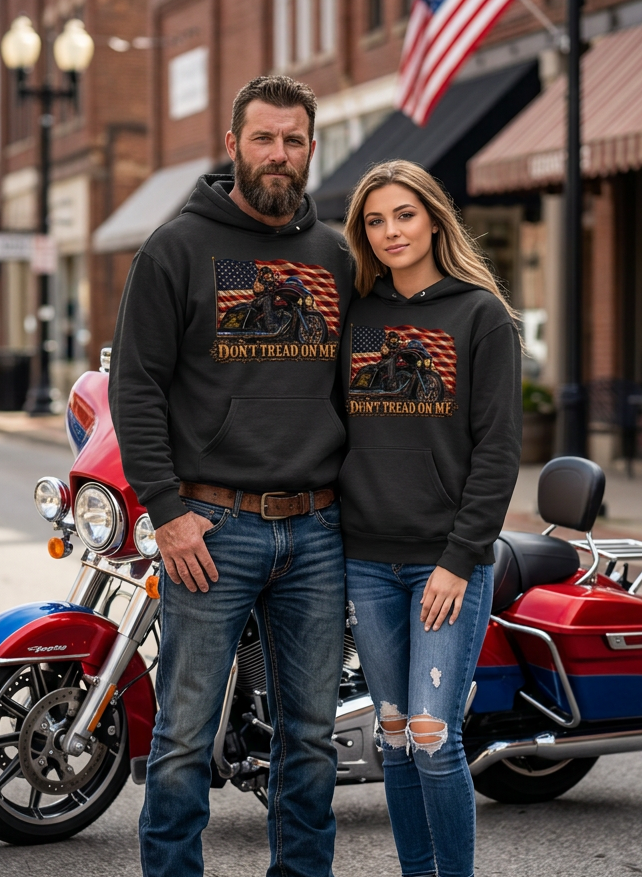 Couple in black Don't Tread Doggo premium hoodies with a motorcycle downtown