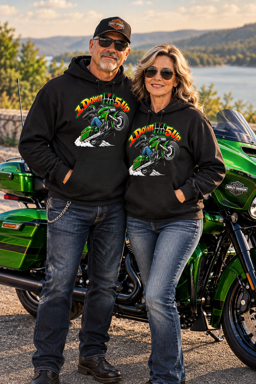 Couple in black Wild Wheelie 1 Down 5 Up hoodies with a green motorcycle