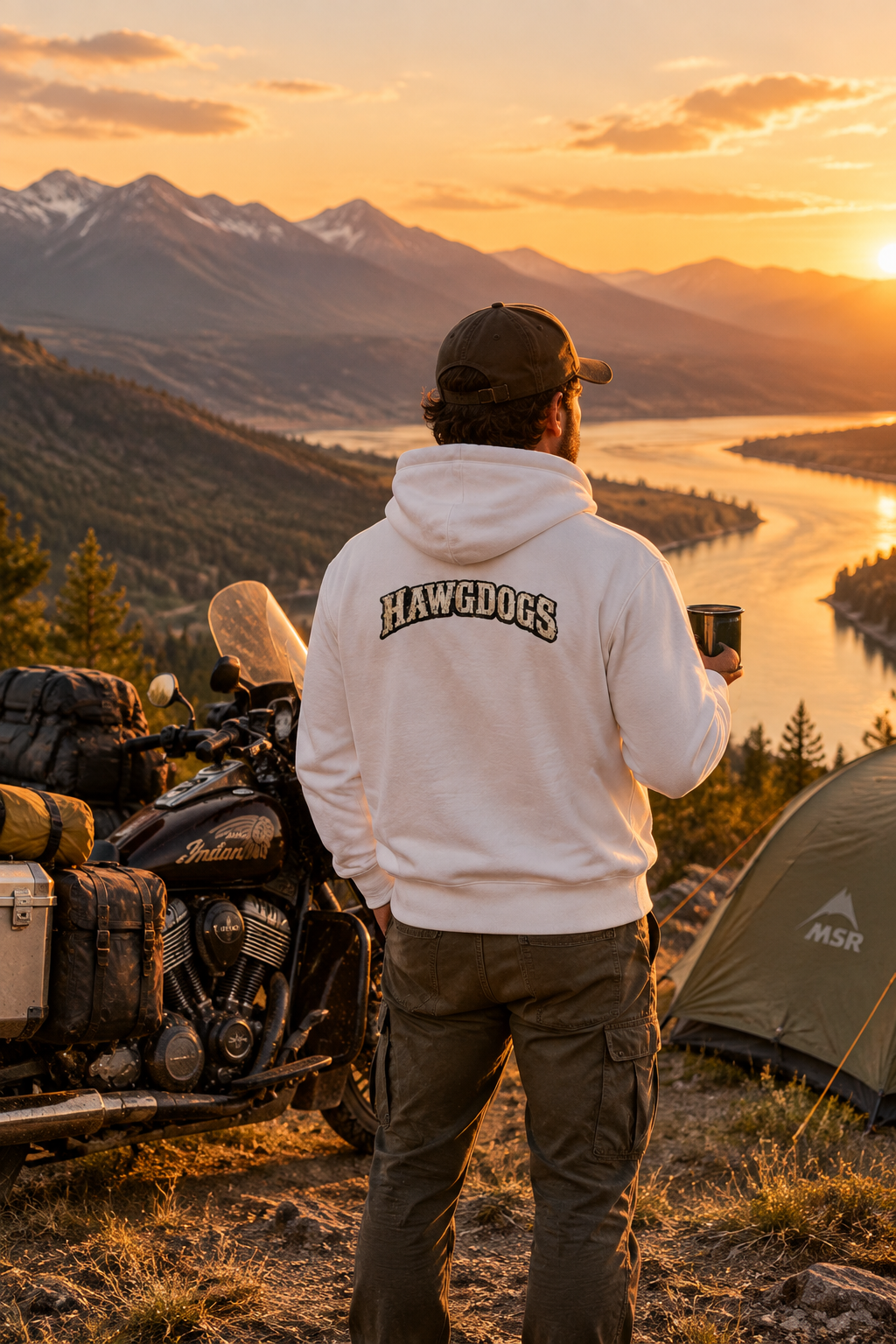 Back of the white Roll Me Away hoodie with the HawgDogs logo by a mountain lake
