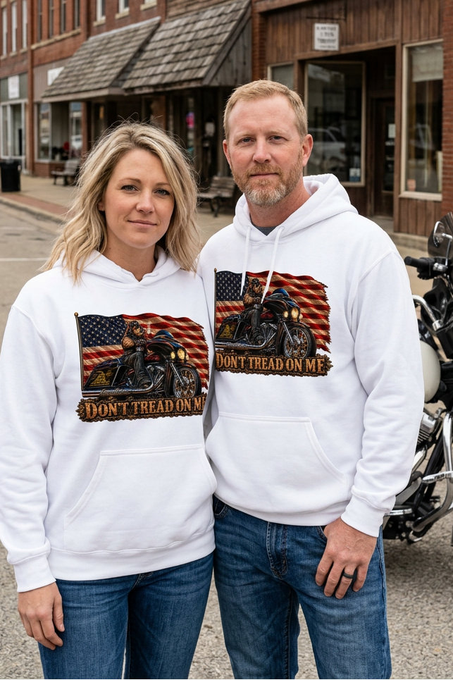 Couple in white Don't Tread Doggo hoodies on a small town main street