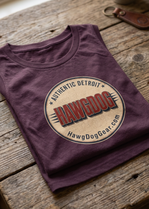 Back of the plum Bagger Dogs women's crewneck tank with the Authentic Detroit patch, folded on a wooden table
