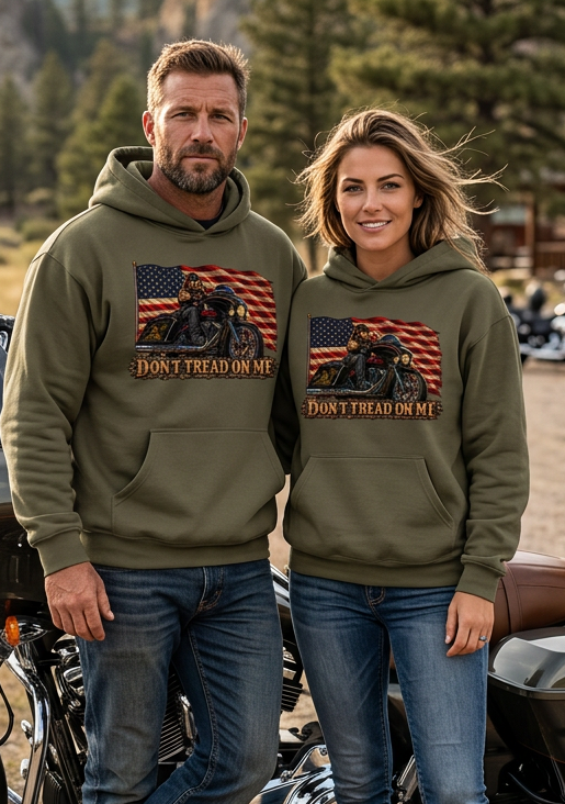 Couple outdoors wearing olive green HawgDogs Don't Tread Doggo Ultimate Fleece-147 Hoodies showing the front flag biker graphic